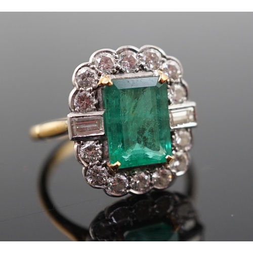 909 - An Art Deco style gold, emerald and diamond set oval cluster ring, the central emerald measuring app... 