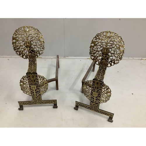 1042 - A pair of cast iron and pierced brass firedogs, height 64cm