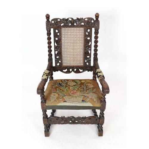 1051 - * * A Charles II carved walnut caned back elbow chair, with a contemporary needlework upholstered se... 