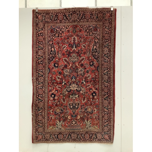 1089 - A Tabriz red ground rug, approximately 220 x 136cm