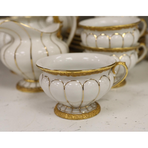 1333 - A Meissen gilt and white glazed porcelain tea service, mid 20th century, comprising a teapot, coffee... 