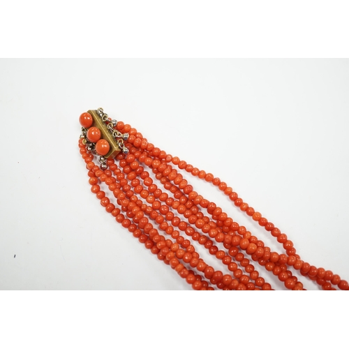 1886 - A five strand coral bead choker necklace, with coral set yellow metal clasp, approx. 44cm.