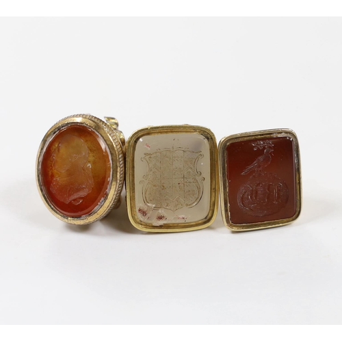 1894 - Three assorted 19th century carnelian set fob seals, including one gold plated and two yellow metal ... 