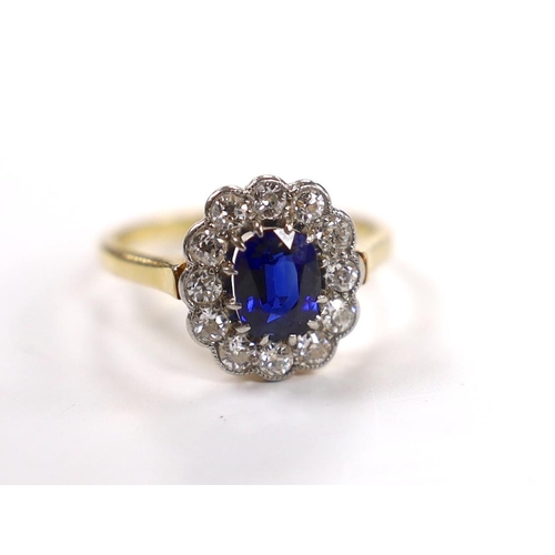 1898 - A 1940's/1950's 18ct, sapphire and millegrain set diamond oval cluster ring, size L/M, gross weight ... 