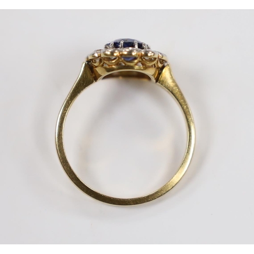 1898 - A 1940's/1950's 18ct, sapphire and millegrain set diamond oval cluster ring, size L/M, gross weight ... 