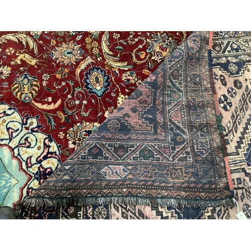 1080 - A North West Persian red ground carpet, approximately 340 x 240cm