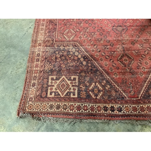 113 - A North West Persian red ground carpet, 254 x 170cm