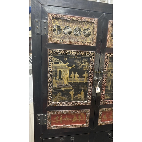 144 - A Chinese lacquered side cabinet, width 109cm, depth 50cm, height 203cm