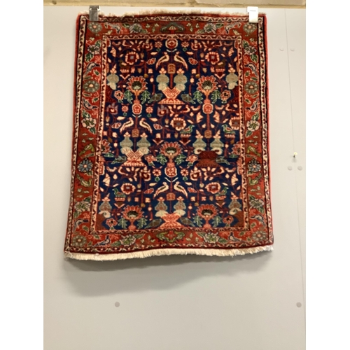 19 - A Caucasian style red ground rug together with a North West Persian blue ground rug, larger 124 x 73... 