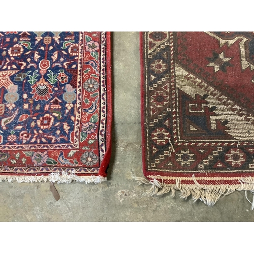 19 - A Caucasian style red ground rug together with a North West Persian blue ground rug, larger 124 x 73... 