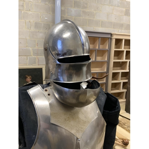 232 - A full suit of reproduction armour on a stand, including chainmail skirt, mounted on a display stand... 