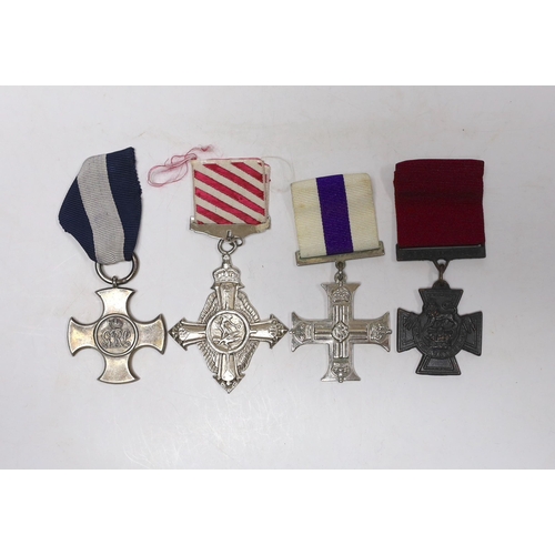 239 - Four well produced replica medals. A Victoria Cross, a Distinguished Service Cross, a Military Cross... 