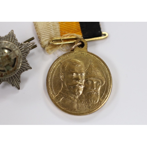 243 - A Russian commemorative House of Romanov medal and a regimental clasp, 1922