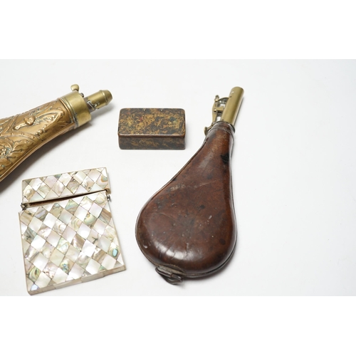 264 - A Victorian embossed brass powder flask, a leather shot flask and a Victorian mother of pearl and ab... 