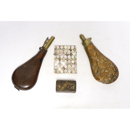 264 - A Victorian embossed brass powder flask, a leather shot flask and a Victorian mother of pearl and ab... 