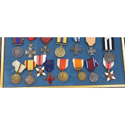 274 - Twenty-seven medals and awards mounted in oak frames, including; French 1939-45 War Medal, Poland Le... 