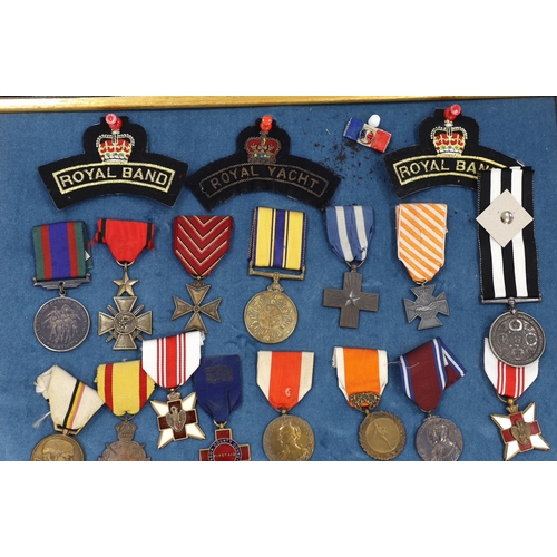 274 - Twenty-seven medals and awards mounted in oak frames, including; French 1939-45 War Medal, Poland Le... 