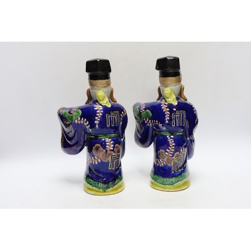 311 - Two early 20th century Japanese enamelled porcelain figures of immortals, 27.5cm high