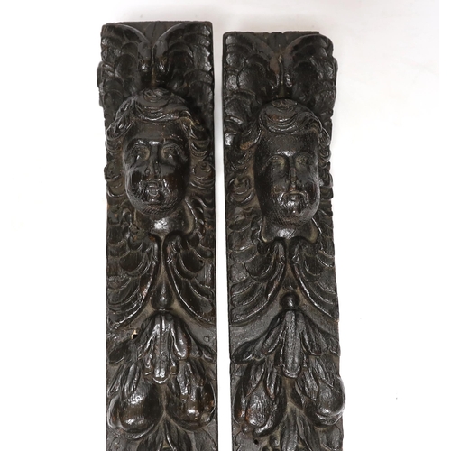 330 - A pair of 17th century carved oak jambs, carved with putti decoration, 39cm