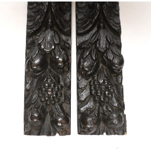 330 - A pair of 17th century carved oak jambs, carved with putti decoration, 39cm