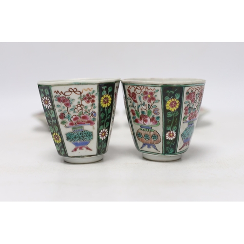 354 - A pair of Chinese Qianlong famille rose octagonal cups and saucers, with panelled floral decoration,... 