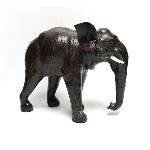 396 - A leather elephant, stamped Liberty to the underside, 30cm wide