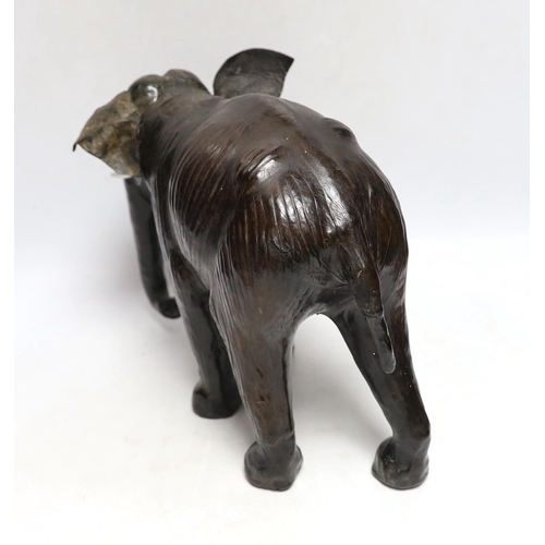 396 - A leather elephant, stamped Liberty to the underside, 30cm wide