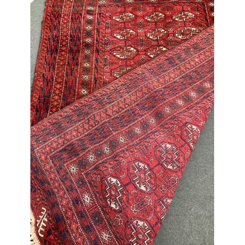 40 - A Bokhara red ground rug, 210cm x 146cm