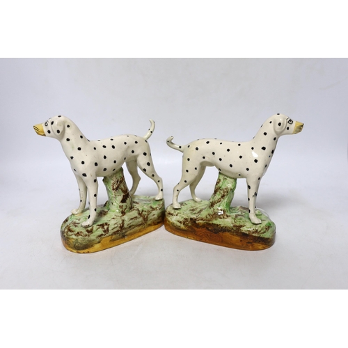 426 - A pair of Staffordshire pottery figures of Dalmatians, 16cm