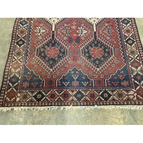 45 - A Caucasian style red ground rug, 146 x 100cm