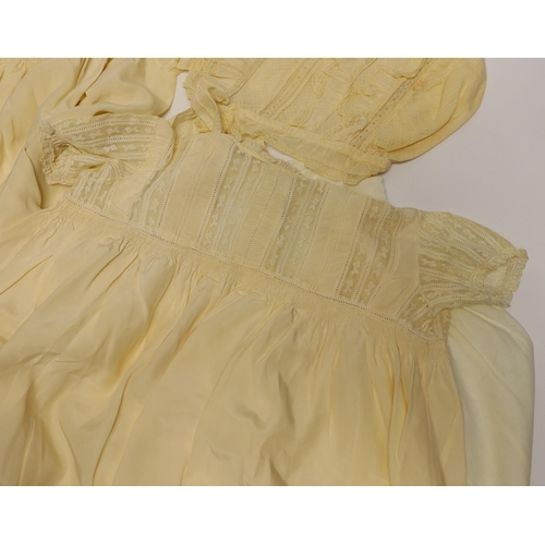 474 - Two 19th century silk baby gowns, a ladies lace trimmed bonnet, a black satin and lace maids apron, ... 