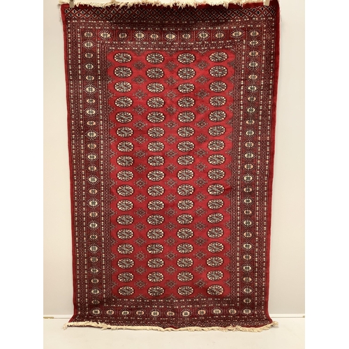 50 - A Bokhara red ground rug, 250 x 155cm