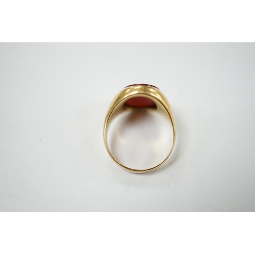 905 - An 18ct and oval intaglio carnelian set signet ring, carved with family crest and motto, size K, gro... 