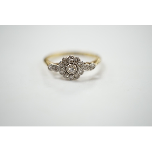 908 - A Belle Epoque 18ct, plat and diamond cluster set target ring, with diamond set shoulders, size P, g... 