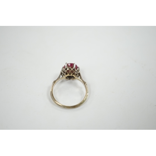 913 - A 750 white metal and solitaire ruby set ring, size M/N, gross weight 3.1 grams.