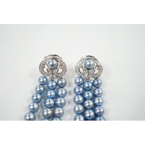 917 - A modern pair of white metal, diamond chip cluster and bluey/grey three row cultured pearl tassel dr... 