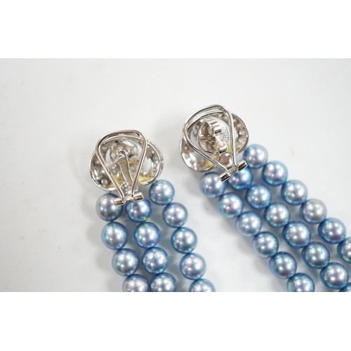 917 - A modern pair of white metal, diamond chip cluster and bluey/grey three row cultured pearl tassel dr... 