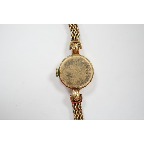 940 - A lady's 9ct gold Jaeger LeCoultre manual wind wrist watch, on an associated 9ct gold bracelet, over... 