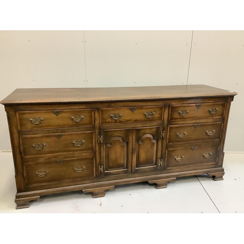 109 - A reproduction 18th century style oak low dresser, width 196cm, depth 54cm, height 90cm