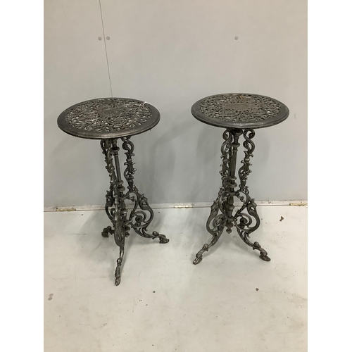 10 - A pair of Victorian style circular cast metal tripod tables, diameter 36cm, height 72cm