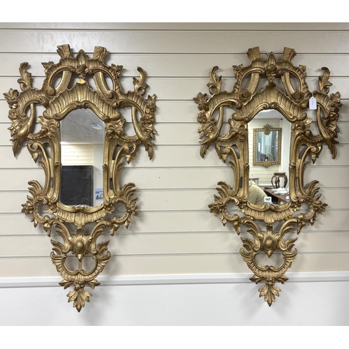 147 - A pair of 18th century style carved giltwood wall mirrors, width 64cm, height 114cm