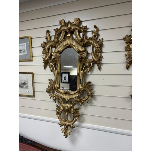 147 - A pair of 18th century style carved giltwood wall mirrors, width 64cm, height 114cm