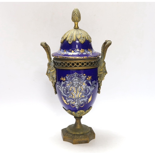 264 - A Limoges style porcelain ormolu mounted urn and cover, 29cm high