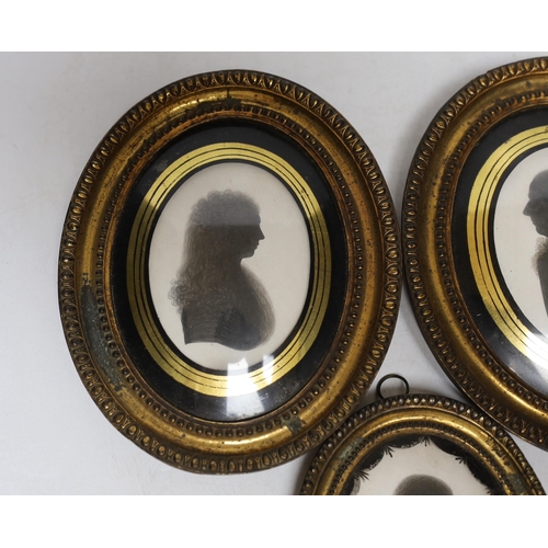 270 - Three late Georgian silhouette portraits, verre eglomise mounts, largest 17cm high