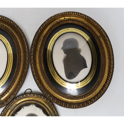 270 - Three late Georgian silhouette portraits, verre eglomise mounts, largest 17cm high