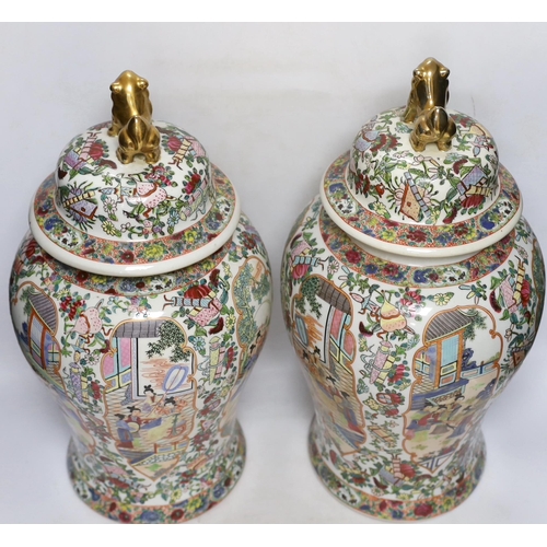 292 - A pair of Chinese famille rose lidded vases, 49cm high