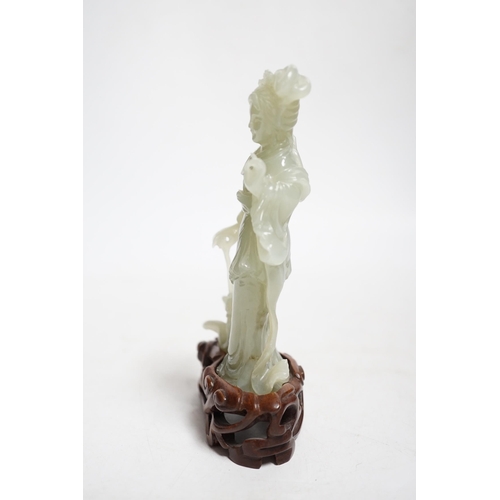 392 - A Chinese celadon jade figure of a lady on wood stand,13cms high.