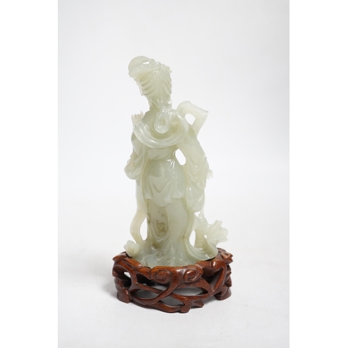 392 - A Chinese celadon jade figure of a lady on wood stand,13cms high.