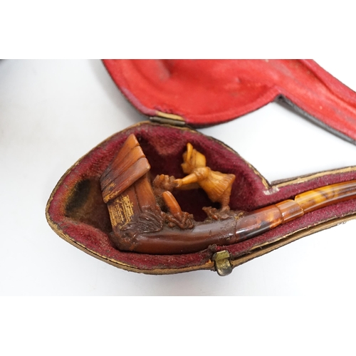 399 - Three cased pipes, one with carved amber novelty bowl, the other two with amber pipe ends, metal mou... 