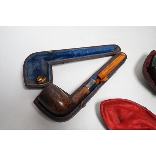 399 - Three cased pipes, one with carved amber novelty bowl, the other two with amber pipe ends, metal mou... 